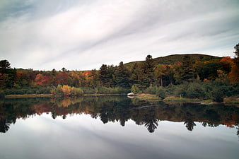 Serene Autumn Lake with Colorful Forest Reflections