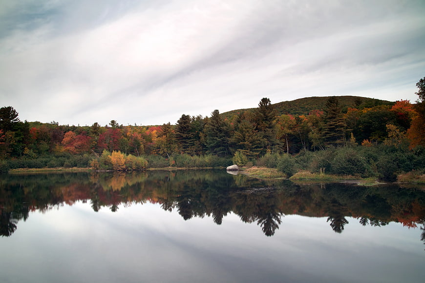 Serene Autumn Lake with Colorful Forest Reflections