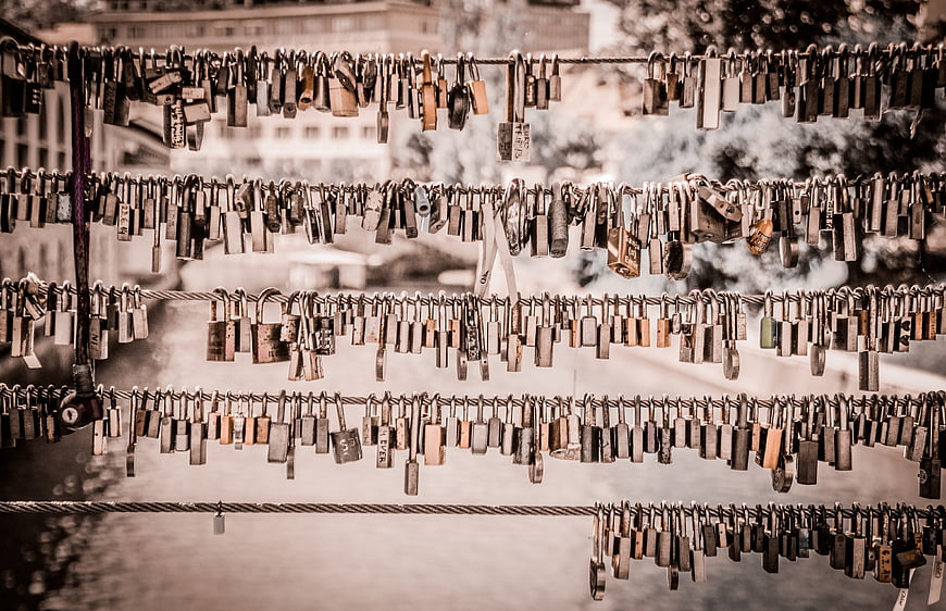 Vintage love locks hanging on bridge cables