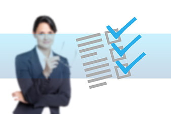 Blurred businesswoman with checklist graphic and checkmarks