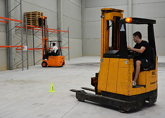 Forklift driver training course in warehouse with practice cone