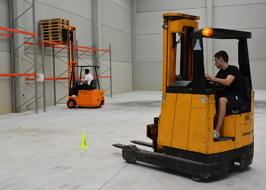 Forklift driver training course in warehouse with practice cone