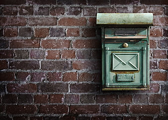 Vintage Green Mailbox on Weathered Brick Wall