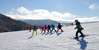 Children Skiing on a Snowy Mountain Slope in Winter