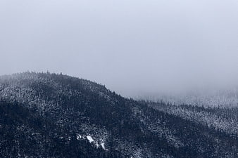 Snowy Mountain Ridge in Thick Winter Fog