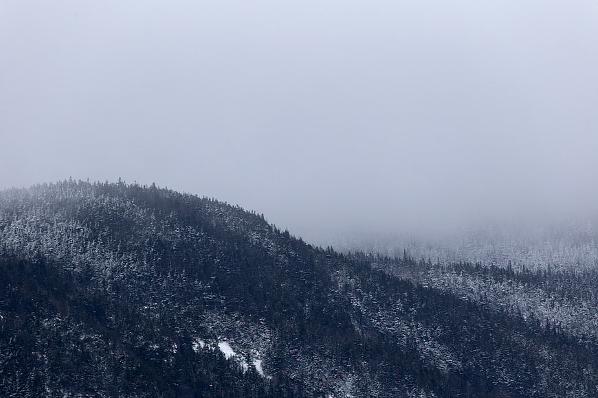 Snowy Mountain Ridge in Thick Winter Fog