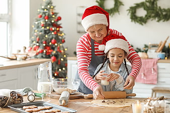 Grandmother and granddaughter baking Christmas cookies together