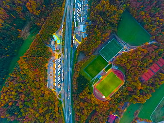 Aerial View of Sports Complex and Highway in Autumn Forest