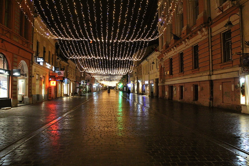Empty Cobblestone Street with Christmas Lights at Night