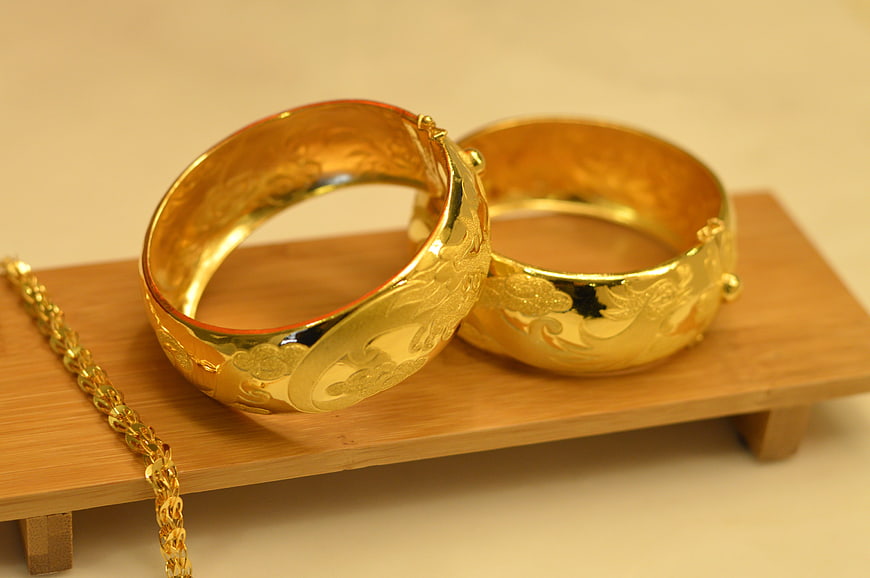 Gold Wedding Bangle Bracelets and Chain on Wooden Stand