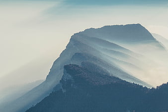 Misty Mountain Ridge at Sunrise with Atmospheric Fog