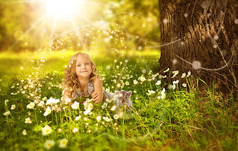 Cute Girl Lying in Grass with Kitten and Magical Sparkles