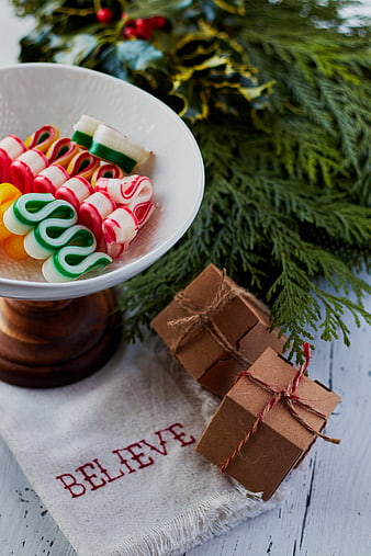 Christmas candy bowl with gifts and festive greenery