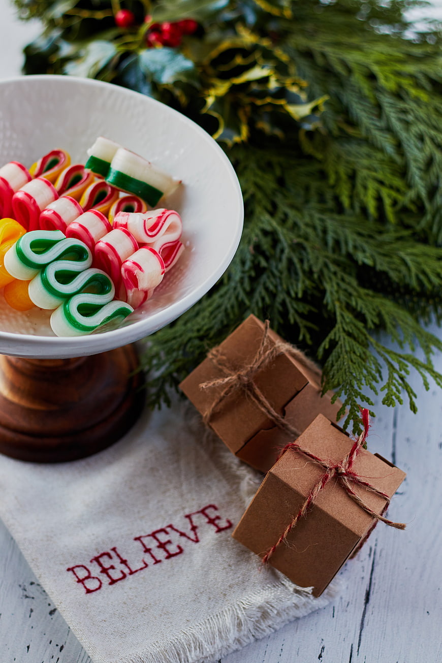 Christmas candy bowl with gifts and festive greenery