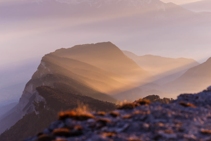 Misty Mountain Peaks at Golden Hour with Sunbeams