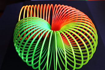 Colorful Twisted Slinky Toy on Dark Background