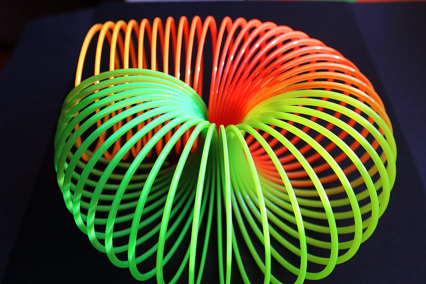 Colorful Twisted Slinky Toy on Dark Background