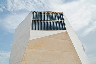 Modern architectural building facade with geometric stone and glass