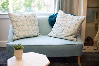 Light blue sofa with textured pillows in bright interior