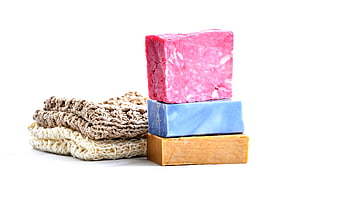 Stack of colorful handmade soap bars with knitted washcloths