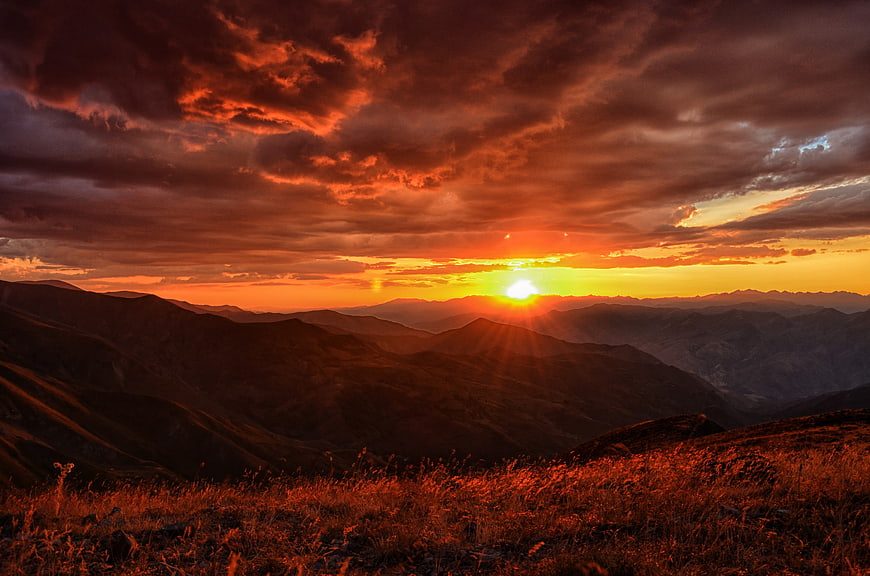 Dramatic Orange Sunset Over Mountain Ranges