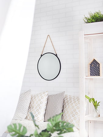 Bright Minimalist Interior with Round Mirror and White Brick Wall