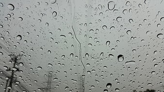Raindrops on a Window Pane with Blurred Background