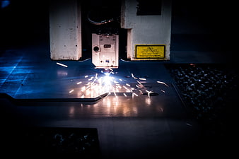 Industrial Laser Cutting Machine Creating Bright Sparks On Metal Sheet