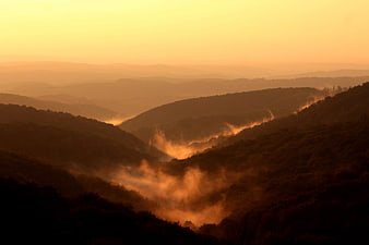 Golden Sunrise Over Misty Mountain Valleys