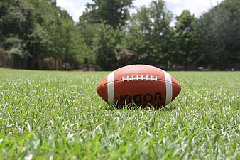 American Football on Green Grass Field