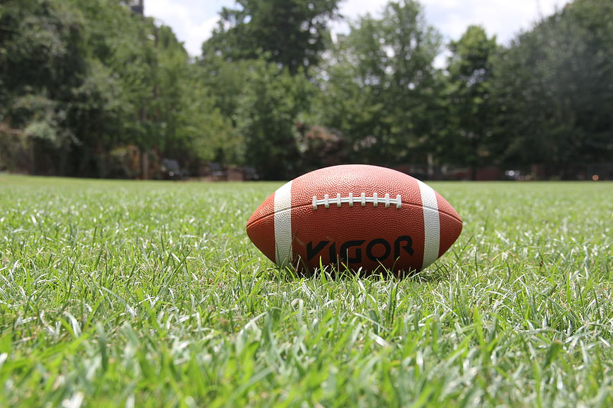 American Football on Green Grass Field
