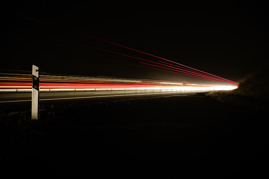 Long exposure light trails on a dark highway at night