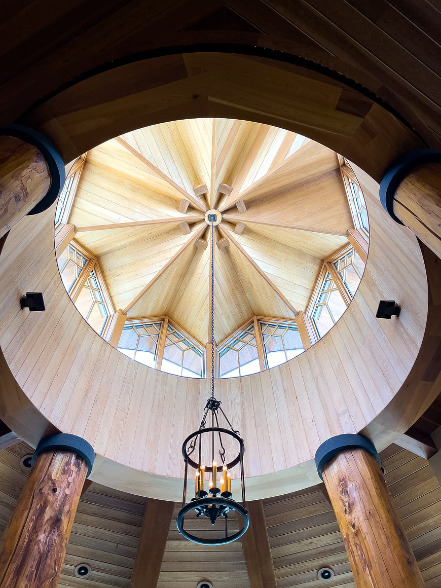 Wooden dome ceiling with skylight and chandelier