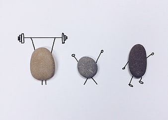 Creative stones with drawn limbs exercising on white background