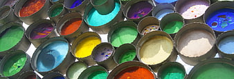 Top view of colorful powder paints in metal cans
