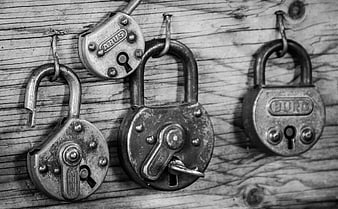 Vintage padlocks hanging on rustic wooden background