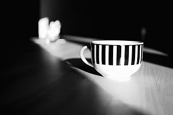 Black and White Striped Coffee Cup on Wooden Table