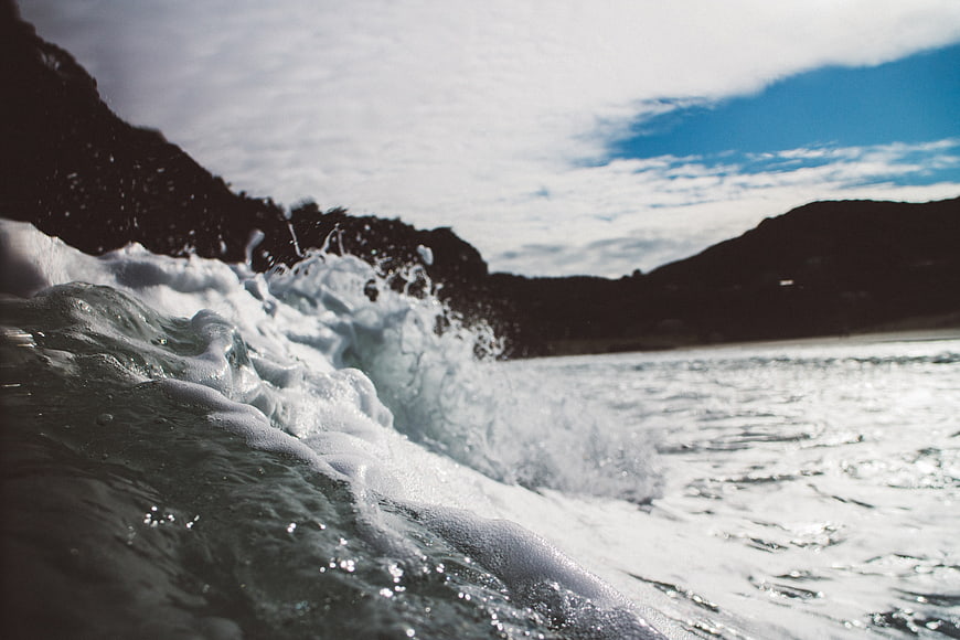Dynamic Ocean Wave Crashing on Rocky Coastline
