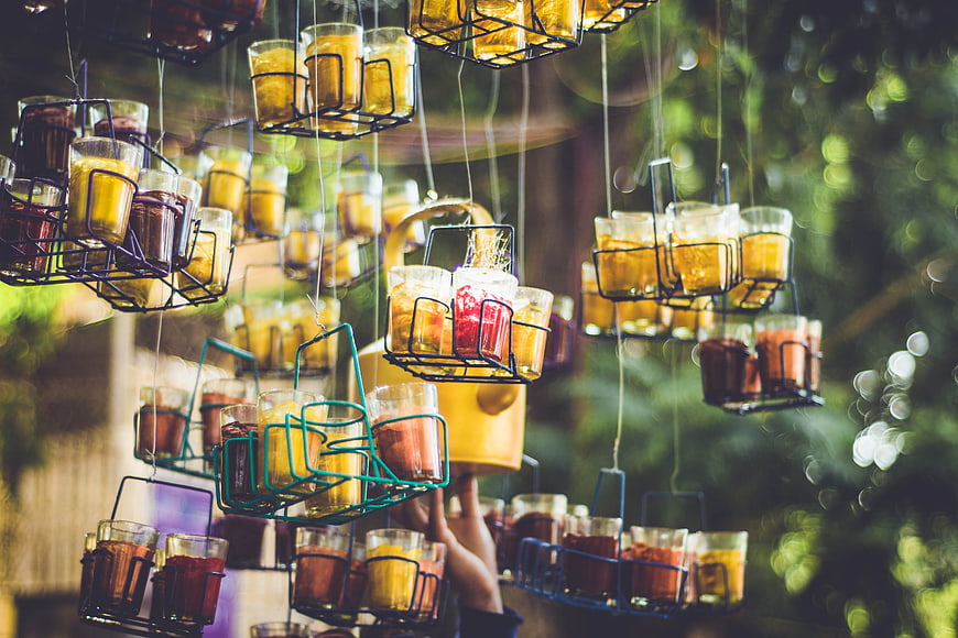 Hanging wire baskets filled with colorful spices and tea outdoors