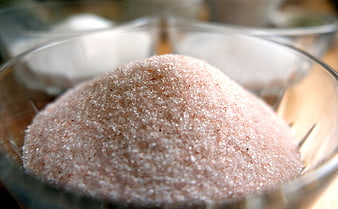Close-up of pink Himalayan salt crystals in a glass bowl