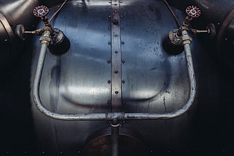 Close-up of vintage industrial metal tank with pipes and valves