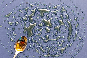 Top View of Honey Spoon and Liquid Splash Pattern