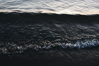Dark Ocean Wave Crashing on Black Sand Beach