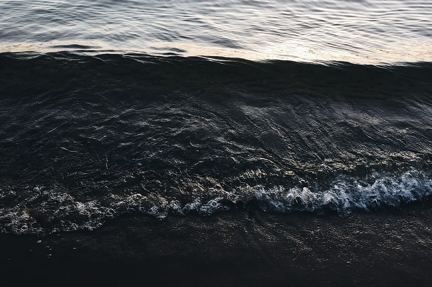 Dark Ocean Wave Crashing on Black Sand Beach