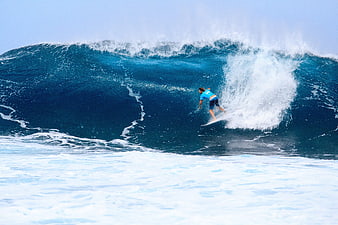 Surfer Riding Large Blue Ocean Wave Barrel
