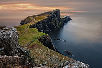 Dramatic Sea Cliffs and Lighthouse at Sunset in Scotland