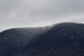 Misty Mountain Ridge with Snow Patches in Grayscale