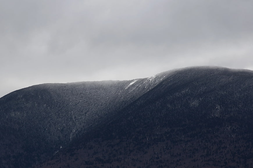 Misty Mountain Ridge with Snow Patches in Grayscale