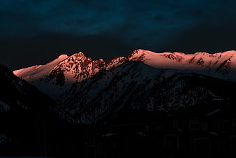 Alpenglow on Snow-Capped Mountain Peaks at Dusk
