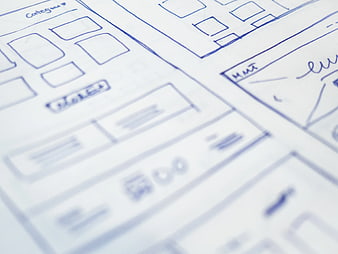 Hand-drawn website wireframe sketches on paper